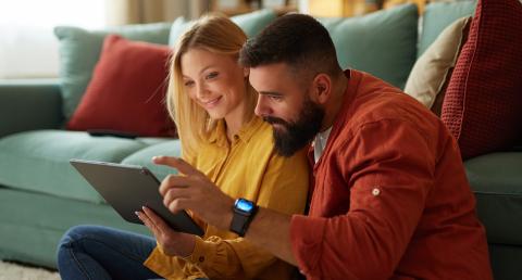 Nainen ja mies katsomassa tablettia